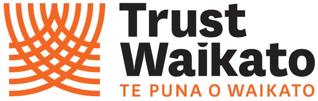 Raglan Surf Lifesaving team logo showing trust and community in Māori and English languages.